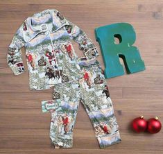 Here's our bestselling Kids Cowboy Santa Christmas Pjs! These button-down Christmas pajamas are Perfect Christmas Morning pajamas for you, your little's, and the whole family! It's a Western Christmas! Yeehaw! Razels' Exclusive PJs are high-quality, well-made pajama sets that are perfect for this Holiday Season! The pictures do not do this one justice! A fun print of old Saint Nick himself with a few of his best horses! This set will become a favorite for the Western at heart, young and old alik Family Christmas Pjs, Matching Family Christmas Pjs, Adult Christmas Pajamas, Cowboy Santa, Christmas Pjs Family, Family Pjs, Unisex Pajamas, Saint Nick, Family Pajama Sets