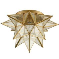 a ceiling light that is made out of glass and gold colored metal, with an intricate star design on the top