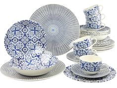 a blue and white dinnerware set on a white background