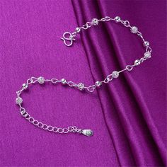 Show off your pedicure and add touch of light-catching shine to your ensemble with this elegant anklet plated in gleaming sterling silver. 0.27'' W x 9.84'' L S-hook clasp Fine silver-plated copper Elegant Anklet, Leg Jewelry, Bridal Necklace Designs, Sterling Silver Anklet, S Hook, Beaded Anklets, Silver Anklets, Anklet Bracelet, Chain Anklet