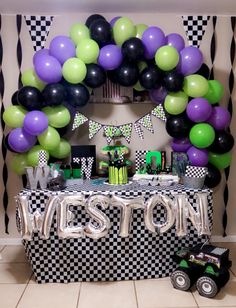 a decorated table with balloons and decorations