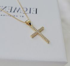 Crystal decor cross pendant necklace. Wear it on it's own or layer it.  Pendant details:  * Material: non tarnish gold filled, cubic zircon * Measurements: 1'H 0.5'W Chain: non tarnish gold filled Comes in our gift ready packaging: vegan leather pouch for safe jewelry storing and branded box  GOLD FILLED Tarnish Resistant. Hypoallergenic. Long Lasting. Gold filled is affordable alternative to solid gold. Hypoallergenic - sensitive skin friendly. With proper care it will last for years. What is G Gold Necklace With Diamonds, Minimalist Yellow Gold Cross Pendant Necklace, Elegant Gold Tarnish-resistant Cross Necklace, Dainty Gold-plated Cross Necklace Gift, Elegant Gold-tone Cross Necklace, 14k Gold Tarnish-resistant Cross Pendant Necklace, Diamond Cross Necklace, Rhinestone Cross, Gold Cross Necklace