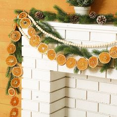 an orange slice garland is hanging on the fireplace