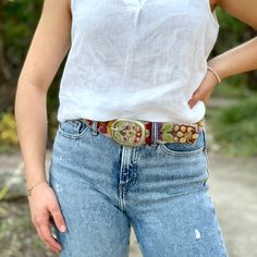 A Peruvian style staple meticulously crafted by hand, this embroidered wool belt features elaborate floral embroidery in mystifying colors, pressed studs and a silver metal buckle. Imported. Exclusive. Sizes: S (24-32"), M (28-36"), L (34-42"), XL (38-46"). Approx. 1-7/8" Wide. Color: Taupe Bohemian Multicolor Belts For Spring, Bohemian Embroidered Belt For Spring, Bohemian Antique Belt Buckles For Festivals, Artisan Embroidered Adjustable Belts, Adjustable Artisan Embroidered Belt, Bohemian Adjustable Belt With Antique Buckle, Adjustable Bohemian Belt With Antique Buckle, Spring Festival Fabric Belt, Folk Style Multicolor Fabric Belt