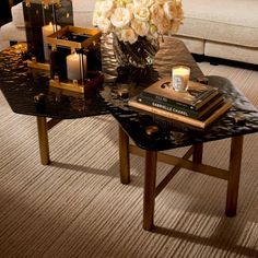 a coffee table with flowers and candles on it