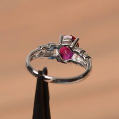 It is a lab ruby ring. The main stone is 7 mm*9 mm oval cut.weight about 2.32 carats. The basic metal is sterling silver and plated with rhodium. To change the metal to a solid gold (white/rose) or platinum is also available, please ask for a quotation if you want. You can also go to my shop Home for more elegant rings: https://www.etsy.com/shop/godjewelry?ref=hdr_shop_menu Ruby is the July birthstone. More ruby rings: https://www.etsy.com/shop/godjewelry?section_id=20709238 Customization is alw Oval Lab-created Ruby Ring For Anniversary, Oval Lab-created Ruby Promise Ring, Oval Ruby Birthstone Ring With Prong Setting, Anniversary Ring With Polished Lab-created Ruby, Anniversary Rings With Polished Lab-created Ruby, Round Polished Lab-created Ruby Ring, Anniversary Ruby Birthstone Ring With Polished Finish, Silver Marquise Cut Ruby Ring, Silver Ruby Ring With Marquise Cut