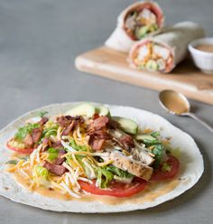 a taco salad with meat, lettuce and tomatoes on a tortilla