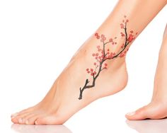 a close up of a person's foot with a tattoo on the side of it