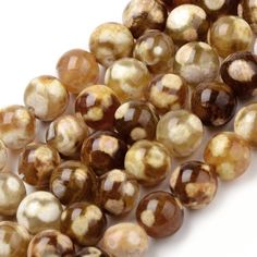 some brown and white beads on a white surface