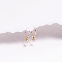 Golden Rutilated Quartz Minimalist Drop Earrings for Her - Gifts under 40 - Mothe's Day - Genuine Quartz Boho style jewelry - Golden crystal Gemstones: 9x6mm approximately Bezel: Vermeil Gold (14k Gold over Sterling Silver) Ear Wires: 14K Gold Filled Wire: 21 gauge / 0.70mm thick Wire Diameter: 15mm Gemstone: Genuine Golden Rutilated Quartz Note that due to the handmade nature of these genuine stones, measurements are approximately and might vary slightly for each stone. Made in the USA.   Je... Minimalist Faceted Drop Earrings, Minimalist Everyday Faceted Earrings, Minimalist Faceted Everyday Earrings, Minimalist Gemstone Hoop Earrings For Gift, Dainty Faceted Everyday Earrings, Golden Crystal, Golden Rutilated Quartz, Boho Style Jewelry, Rutilated Quartz