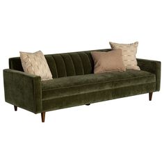 a green velvet couch with two pillows on it's back and one pillow in the middle