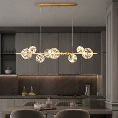 a dining room table and chairs with lights hanging from the ceiling above it in a modern kitchen