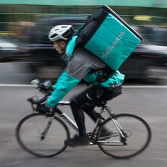 a person riding a bike with a backpack on it's back