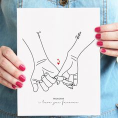 two hands holding a paper with the words love written on it