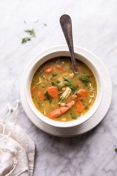 a white bowl filled with soup and carrots