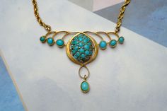 "STORY --------- Crafted in 9 carat gold, this vintage Art Nouveau style necklace features a pretty organic floral pendant section inset with natural green & blue turquoise, and is fastened with a gold rope twist chain and bolt ring. Despite some age related wear, it remains wearable today... SPECIFICS -------------- Metal: 9 carat gold (tested, hallmark illegible) Stones: Turquoise Dimensions: 15.5\" long Condition Notes & Care: Overall in expected vintage condition with some minor denting, wea Vintage Yellow Gold Cabochon Necklace, Victorian Turquoise Necklace For Wedding, Victorian Turquoise Gemstone Jewelry, Vintage Turquoise Necklace As A Gift, Antique Hallmarked Turquoise Jewelry, Victorian Hallmarked Turquoise Jewelry, Victorian Turquoise Hallmarked Jewelry, Turquoise Vintage Jewelry With Vintage Charm, Antique Turquoise Cabochon Jewelry