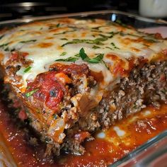 lasagna casserole with meat and cheese in a glass dish on the stove