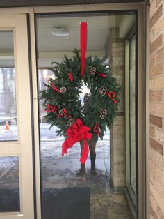 a christmas wreath on the front door of a building