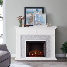 a living room with a fireplace and pictures on the mantle