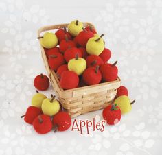 a basket filled with apples sitting on top of a table