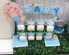 a baby shower is set up in the grass with its name and it's decorations