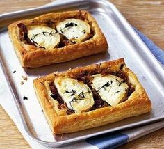 two square pastries sitting on top of a metal tray