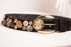 The most amazing, one of a kind button embellished leather belt with decorative buckle by Suzy Roher Accessories. This gorgeous piece is completely covered with many, many super unique buttons! The buckle of this belt features a large rose medallion.   By far, the coolest belt I've ever seen! Size Large; Fits up to a 32 inch waist. FREE SHIPPING TO USA AND CANADACanadians shop DUTY FREE Luxury Bohemian Belt Buckles With Belt Included, Belt Buckles For Wxtra Wide Belts, Luxury Vintage Belts And Suspenders With Antique Buckle, Cloth Tote Bag, Unique Buttons, Rose Medallion, Purple Belt, Statement Belt, Unique Handbags