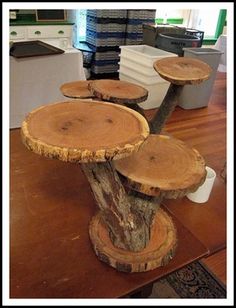 three tree stumps are stacked on top of each other in the middle of a room