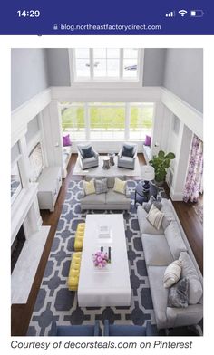 an aerial view of a living room with couches, tables and chairs in it