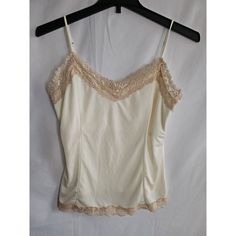 Add Some Color To Your Wardrobe With This Victoria's Secret Ivory Camisole. Perfect For Any Occasion, This Colorful Camisole Is Made Of High-Quality Polyester And Features Adjustable Straps For A Comfortable Fit. The Sleeveless Design Is Ideal For Hot Summer Days, And The Camisole Is Available In Size Large, Making It Perfect For Any Woman. Stay Stylish And Cool With This Victoria's Secret Camisole. The Camisole Is Also Equipped With Features Such As Straps And Accents, Making It An Excellent Ad Hot Summer, Summer Days, Women's Intimates, Adjustable Straps, Comfort Fit, Victoria's Secret, Slip On, Wardrobe, Cream