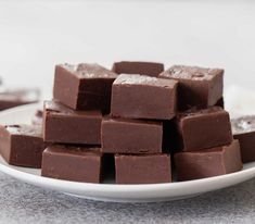 a white plate topped with chocolate squares on top of a table