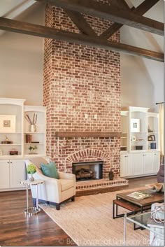 a living room filled with furniture and a fire place in the middle of an open floor plan