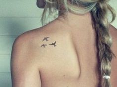 a woman with two birds on her back