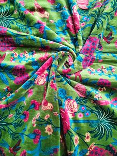 the fabric is green with pink flowers on it