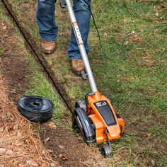 a man is using a lawn mower to cut the grass