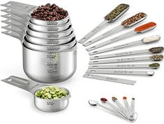 stainless steel measuring spoons and measuring cups are arranged in the shape of a stack