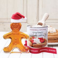 a gingerbread man cookie tin next to a can of snowmall kitchen cream