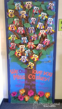 a door decorated with owls and leaves for the school's fall bulletin board contest