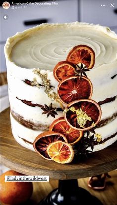 a white cake with orange slices on it