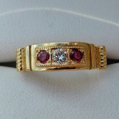 18ct Yellow gold Ruby and Diamond 3 / stone Victorian Style ring, London hallmark 1988. Set with 1 x 10ct (3mm) Diamond and 2 x 0.05ct Rubies. Total gold wgt 3.7gms.  Please see my other Ruby & Diamond rings. This ring can be sized up from M1/2  to at least R/T if required, please let me know. Victorian Wedding Ring, Rose Diamond Ring, Victorian Style Rings, Ruby Diamond Rings, 3 Stone Rings, Gold Engraving, Red Band, Ruby Diamond, Diamond Cluster Ring