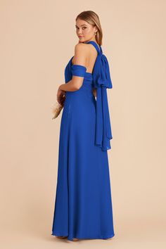 a woman wearing a blue dress with an open back and bow at the neckline