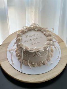 a birthday cake with white frosting on a wooden platter