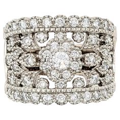 Ring size: 7.75 This beautiful, ornate diamond band ring fills the finger with shimmering sparkle. The flower cluster at the center is surrounded by intricate cut outs and subtle milgrain detailing, while the exceptional diamonds glitter from every angle. Though it is wide in size, it remains delicate and feminine while making a big statement on the finger. Ring size: 7.75 Metal: 14K White Gold Weight: 13.12 grams Diamonds: 1.425 ctw Diamond cut: Round Brilliant Diamond color: E-F Diamond clarit Diamond Band Ring, Flower Cluster, Diamond Glitter, Diamond Ring Settings, Wide Band Rings, Diamond Rings Bands, Antique Diamond, Finger Ring, Diamond Band