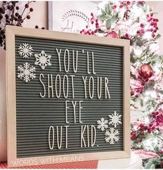 a sign that says you'll shoot your eye out kid on it in front of a christmas tree