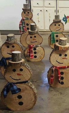 a group of wooden snowmen sitting on top of a kitchen counter next to each other