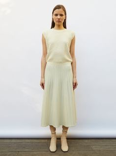 this long, fine knit skirt with a slightly flared cut, made in italy in a fine, openworked jewel knit, is characterized by its lovely fullness. its tone-on-tone textured knit stitches are like fine strings of beads while its wide, scalloped, girdling waistband will flatter any silhouette. in a "natural" color, this luminous, luxurious knit skirt can be worn all year round with tights, boots and molli's  round-collared tweed knit top. the model is 1.78 m tall and wears a size s. Small Scallops, Burgundy Loafers, Tights Boots, Khaki Jeans, Knit Stitches, Textured Knit, Knit Skirt, Knitting Stitches, Natural Color