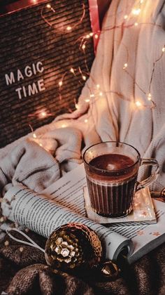 a cup of hot chocolate sitting on top of a book