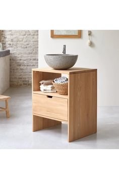 a bathroom with a sink and wooden cabinet