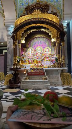 a person sitting at a table in front of a shrine