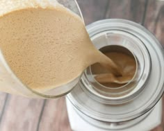 a glass jar filled with liquid on top of a wooden table